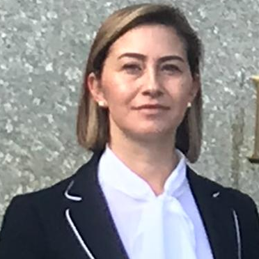 A person in a suit
Description automatically generated